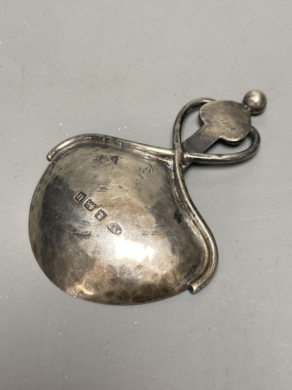 A George V Arts & Crafts planished silver caddy spoon by Albert Edward Jones, Birmingham, 1919, 78mm, 18 grams,